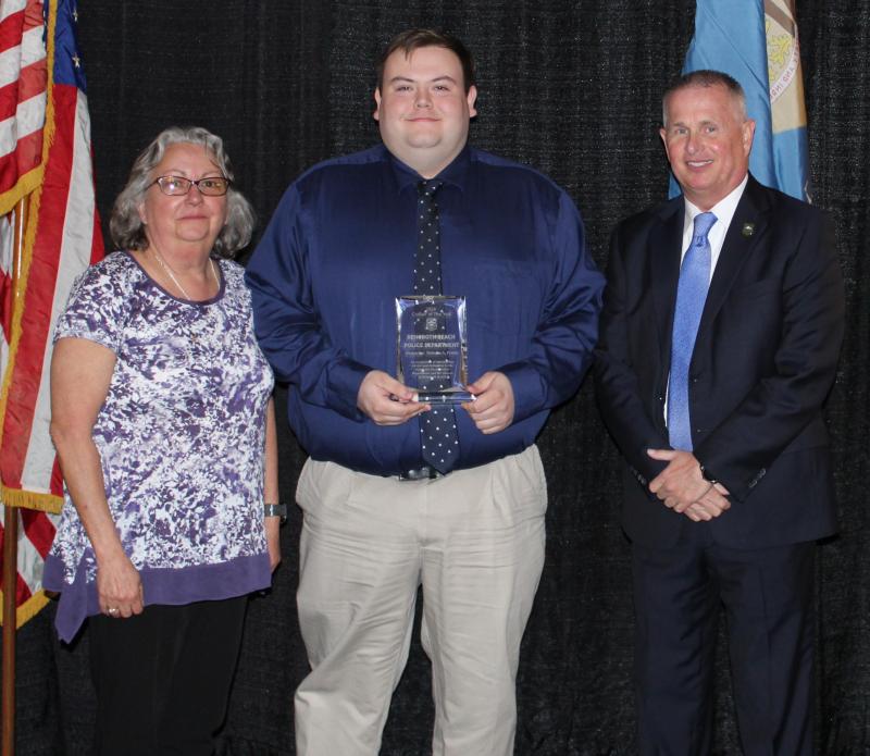 At the presentation of the 2018 Civilian of the Year Award are (l-r) Public Safety Answering Point Manager Tammy Ketterman, Dispatcher Nicholas Priddy, recipient, and Police Chief Keith Banks.